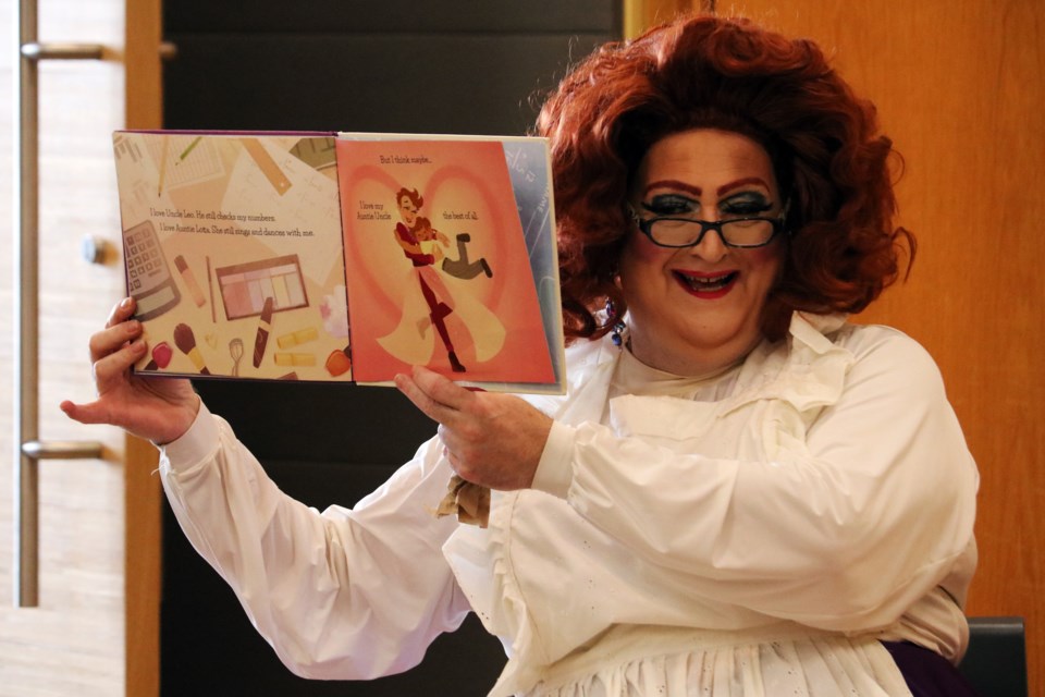 E'Claire reads Auntie Uncle by Ellie Royce to a crowd of 53 people during Drag Queen Storytime in the Zima Room at the Bradford West Gwillimbury Public Library, on Saturday, June 10, 2023. 