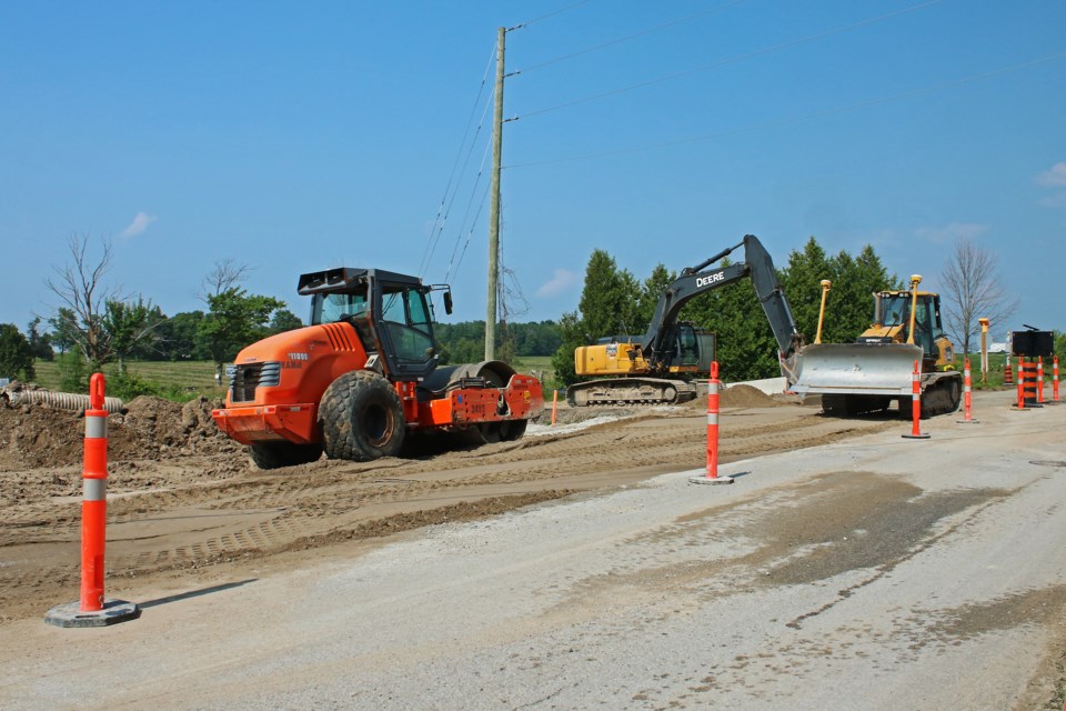 Construction crews continue work on the intersection of Line 5 and Sideroad 10 as part of the South West Arterial Road project in Bradford on Tuesday, July 25, 2023.