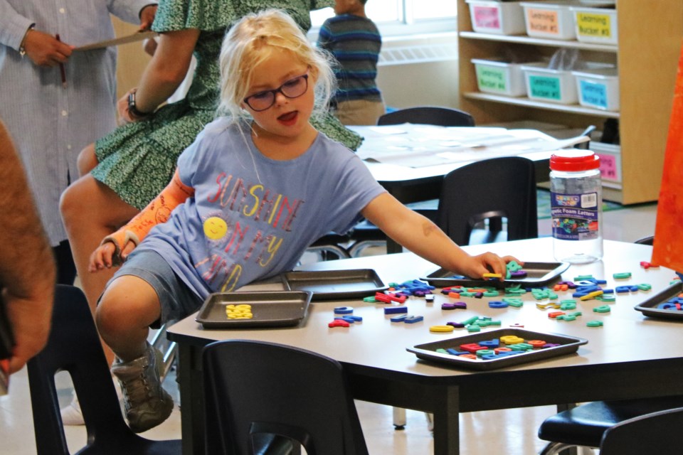 Charlotte, a student in senior Kindergarten, enjoys playing with letters during an open house at Harvest Hills Public School at 400 Crossland Boulevard in Bradford on Tuesday, Oct. 3, 2023.