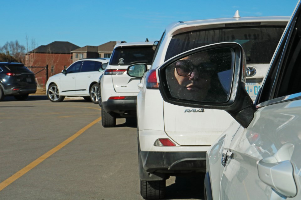 Cindy Saramago is seen waiting in the vehicle pick-up line at St. Charles Catholic School in Bradford on Feb. 6.