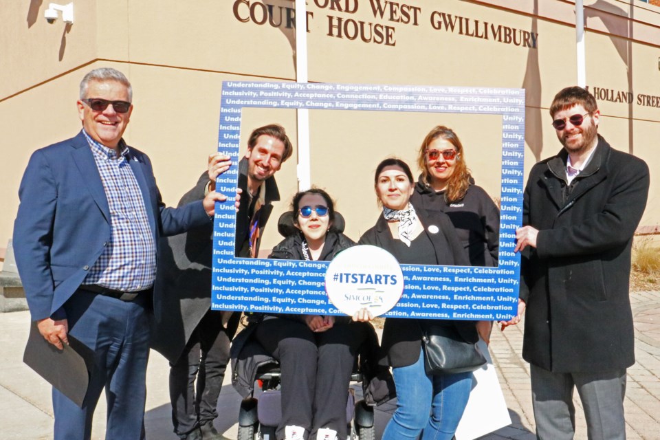 From left: Mayor James Leduc; David di Giovanni, Bradford West Gwillimbury Public Library manager of cultural services; Lexi Tokhi, Samira Rashidian, Gulghutai Tokhi and Matthew Corbett Bradford West Gwillimbury Public Library chief executive officer hold up the #ITSTARTS photo frame during the campaign flag raising at the Bradford West Gwillimbury Court House at 57 Holland St. E. on Monday afternoon, March 4.