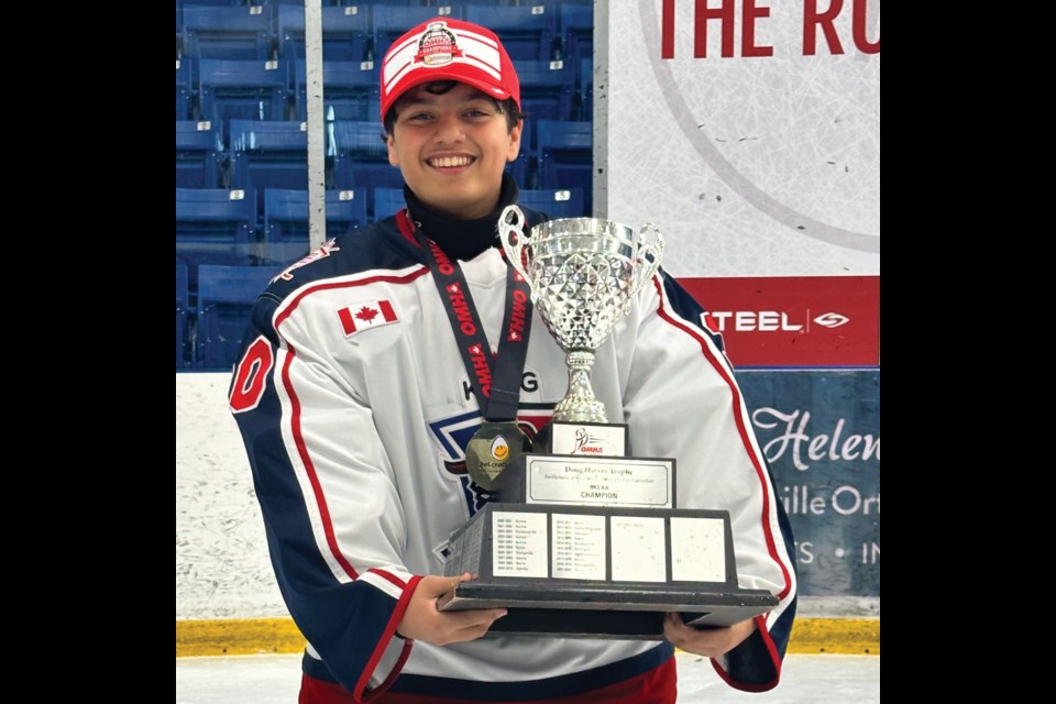 Adam Pasha, goalie for the King Rebellion U13AA, holds the trophy after they won the Ontario Minor Hockey Association championship game at the Sixteen Mile Sports Complex in Oakville on Sunday, April 7.