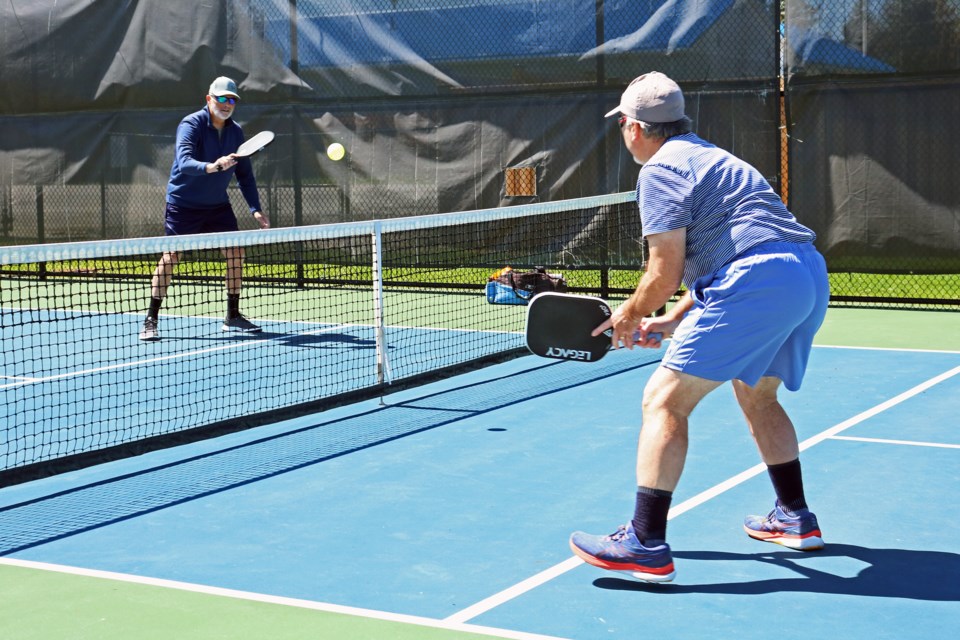 Bill Connery (from left) of Newmarket and Allan Roitner of Aurora play pickleball on the outdoor courts beside the Danube Seniors Leisure Centre in Bradford on Monday, April 22.