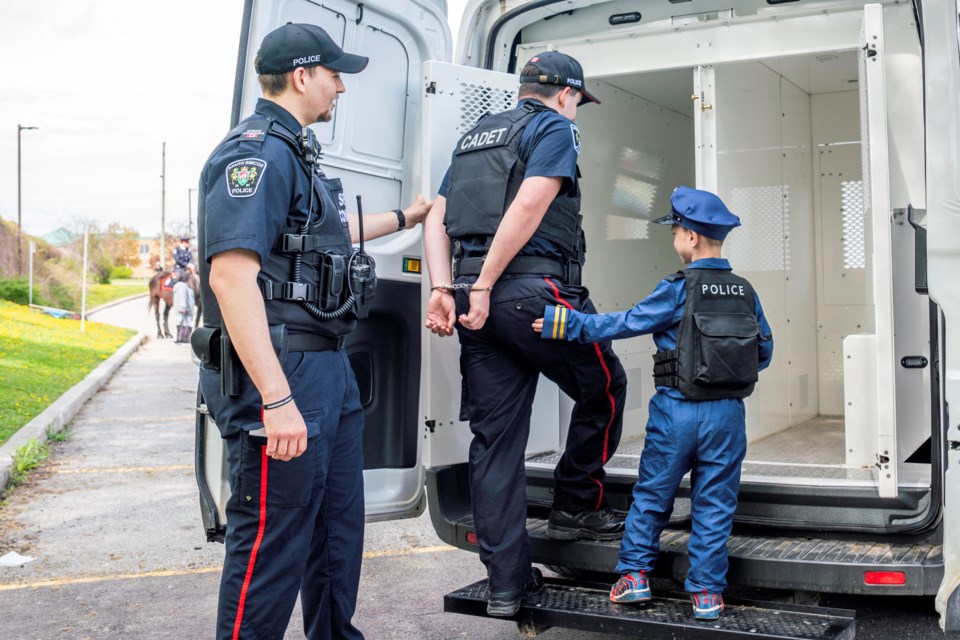 Special constable Jordan takes a cadet into custody at the South Division station in Bradford May 11.