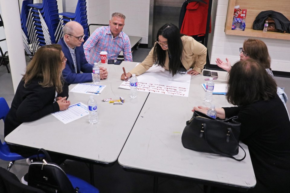 Angelica Cruz, manager of communications and public affairs for Southlake Regional Health Centre, leads a group in discussing how the hospital can grow and expand its facilities and services over the coming decade, during a public meeting at the BWG Leisure Centre on Tuesday, May 14.