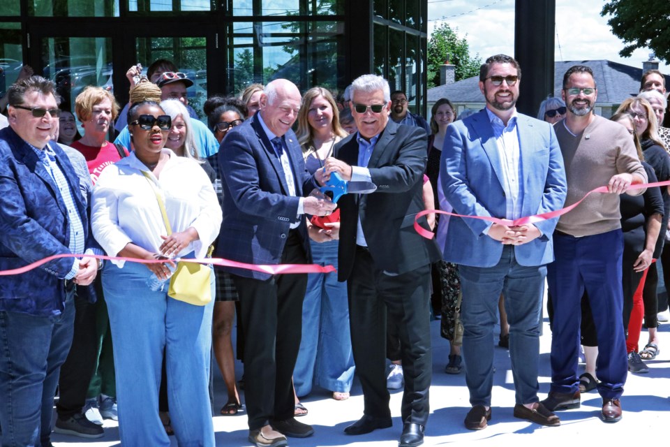 A crowd of residents and guests gather as Tony Van Bynen MP for Newmarket-Aurora (centre left) and Mayor James Leduc (centre right) cut the ribbon at the grand opening of Bradford’s social services and community hub at 177 Church St. on June 27.