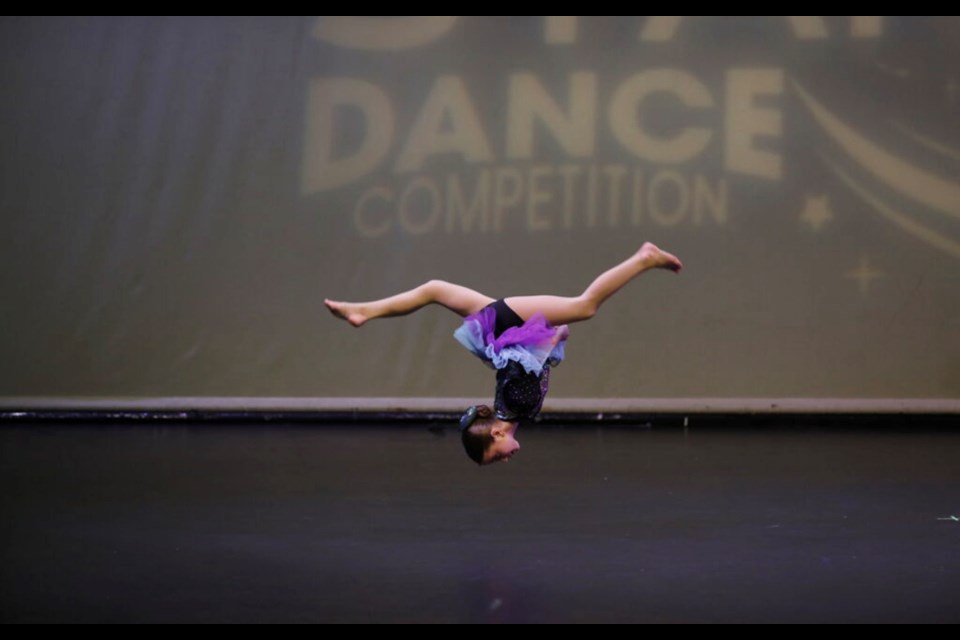 Addison Tamburello performs leaps, flips and other acrobatic moves as part of a dance competition.