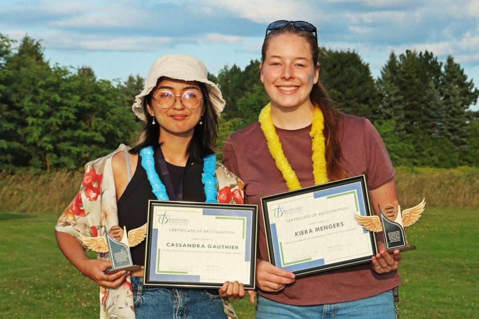 From left: Cassandra Gauthier and Kiera Mengers hold the awards and certificates of recognition they received during the end of season celebration at Bradford Community Church on Thursday, Aug. 22.