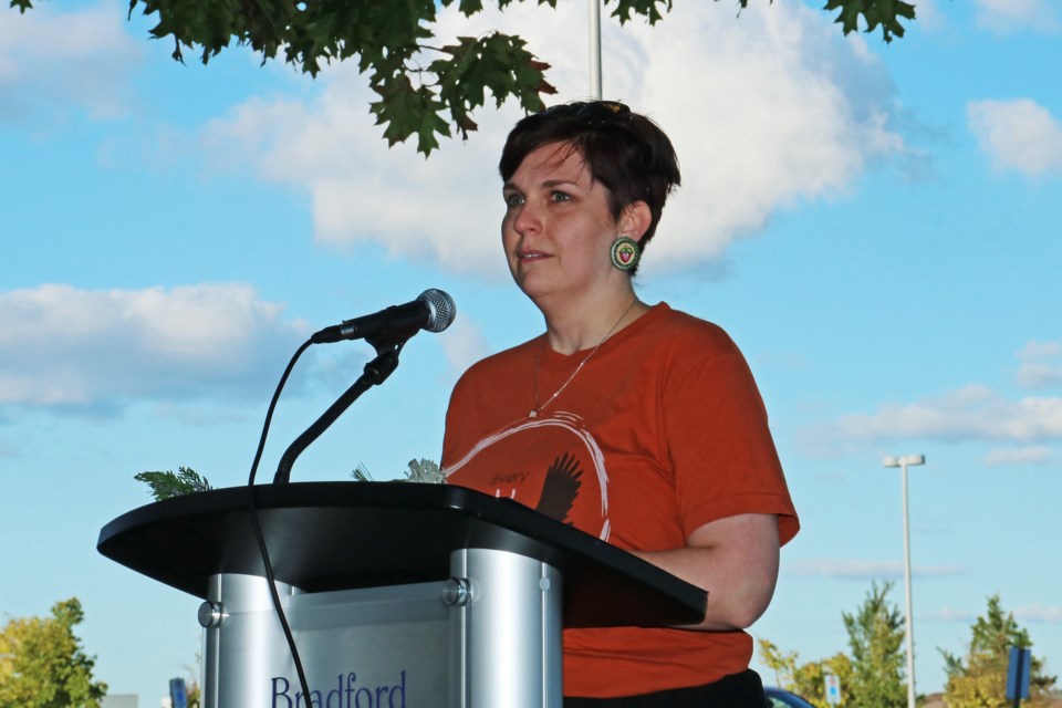 Ashley Mosquera of Odenaang Circle speaks during the a flag-raising ceremony for National Day for Truth and Reconciliation outside the BWG Leisure Centre on Sept. 30, 2024.