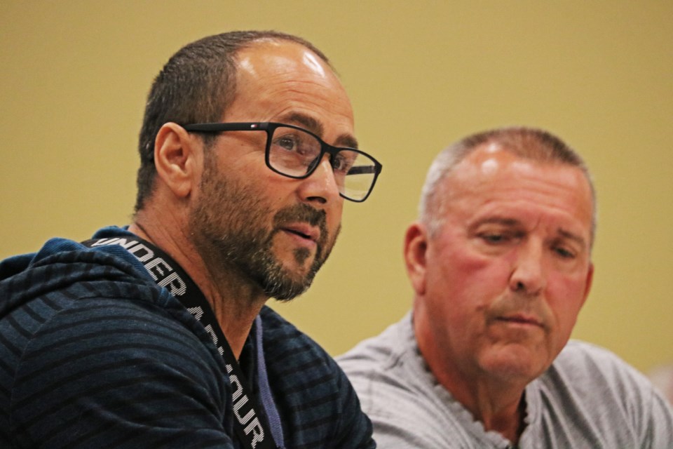 Mario Batista, left, speaks with the help of Earl Galaski during the regular council meeting at the Bradford West Gwillimbury Public Library on Oct. 1.