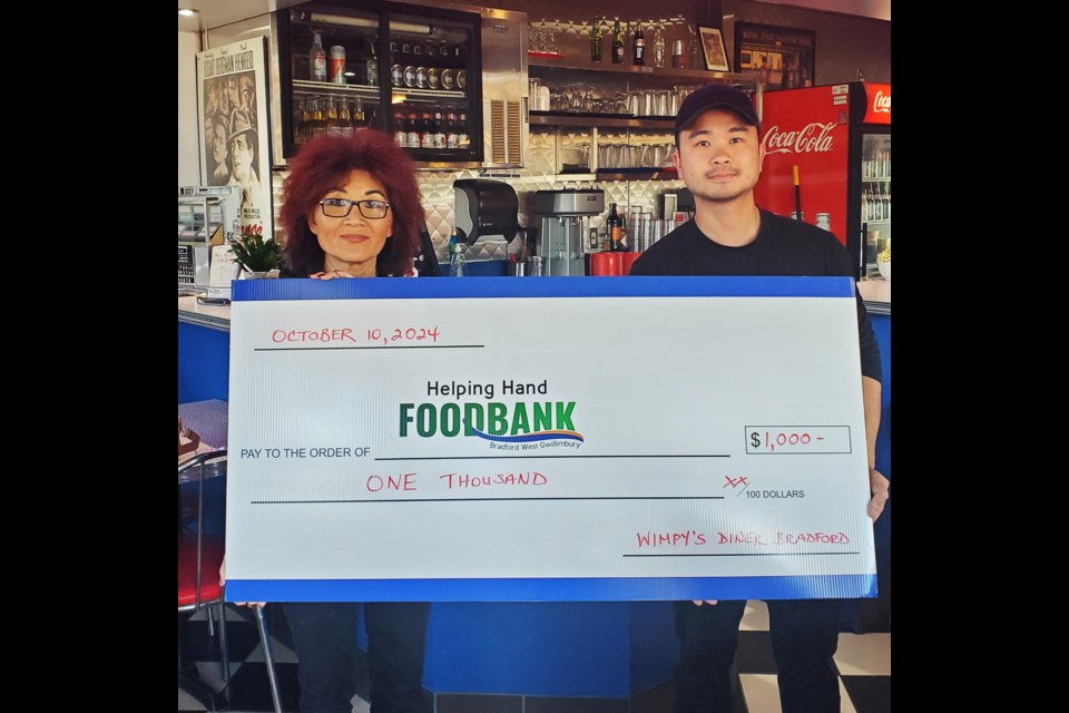 Co-owners of Wimpy’s Diner in Bradford Kate Yip and Davin Pen presented a $1,000 donation to the Helping Hand Food Bank from diner staff on Oct. 10.