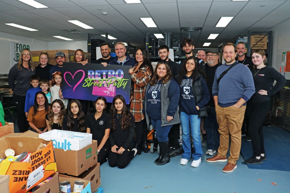 A group of Street Party Collective members, supporters and volunteers helped donate $10,000 worth of food and funds to the Helping Hand Food Bank on Oct. 18.