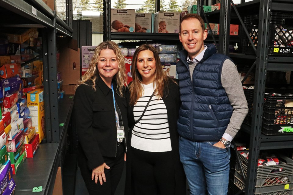 From left: Helping Hand Food Bank executive director Carolyn Khan is seen with Kristine and Jason Mullins who donated $50,000 to the food bank on Nov. 1.