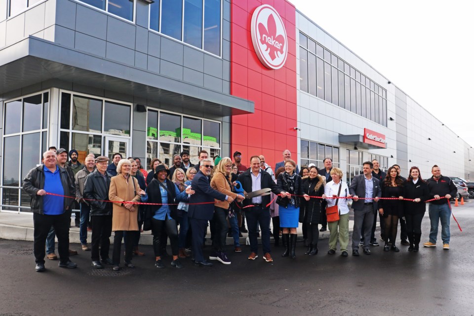 Arlene Kooring-Murray, president of Rieker Shoe Canada Ltd., cuts the ribbon during the grand opening of the company’s new national headquarters, warehouse and retail outlet at 202 Stirling Cres. in Bradford on Nov. 21.