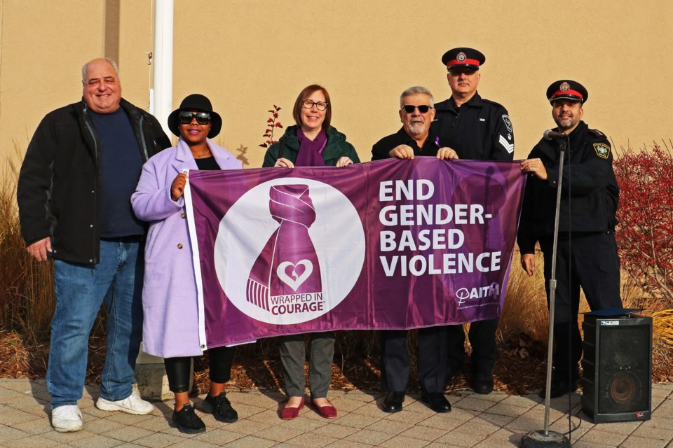 From left: Ward 3 Coun. Ben Verkaik; Ward 1 Coun. Cheraldean Duhaney; Cindy Curry, fundraising co-ordinator of My Sister’s Place, Mayor James Leduc, South Simcoe Police Service Staff Sgt. Sean Willan and Insp. Julio Fernandes hold the Wrapped In Courage flag during a ceremony in recognition of the International Day for the Elimination of Violence Against Women outside the Bradford West Gwillimbury courthouse on Nov. 25.