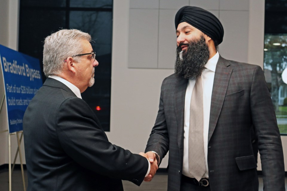 Bradford West Gwillimbury Mayor James Leduc (left) and Ontario Minister of Transportation Prabmeet Sarkaria shake hands as the province announced it has awarded a contract for tree clearing along the western portion of the Bradford Bypass, at the town’s community and social services hub at 177 Church St. on Dec. 17, 2024.