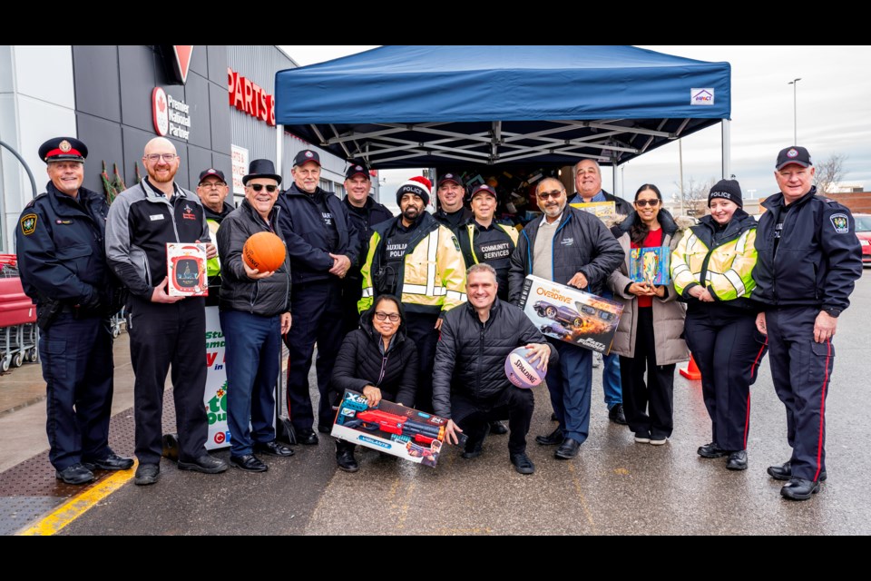 Members of South Simcoe Police, Bradford town council, Canadian Tire General Manager Jeff Bonner and community members all worked together for a successful toy and food drive event on Saturday