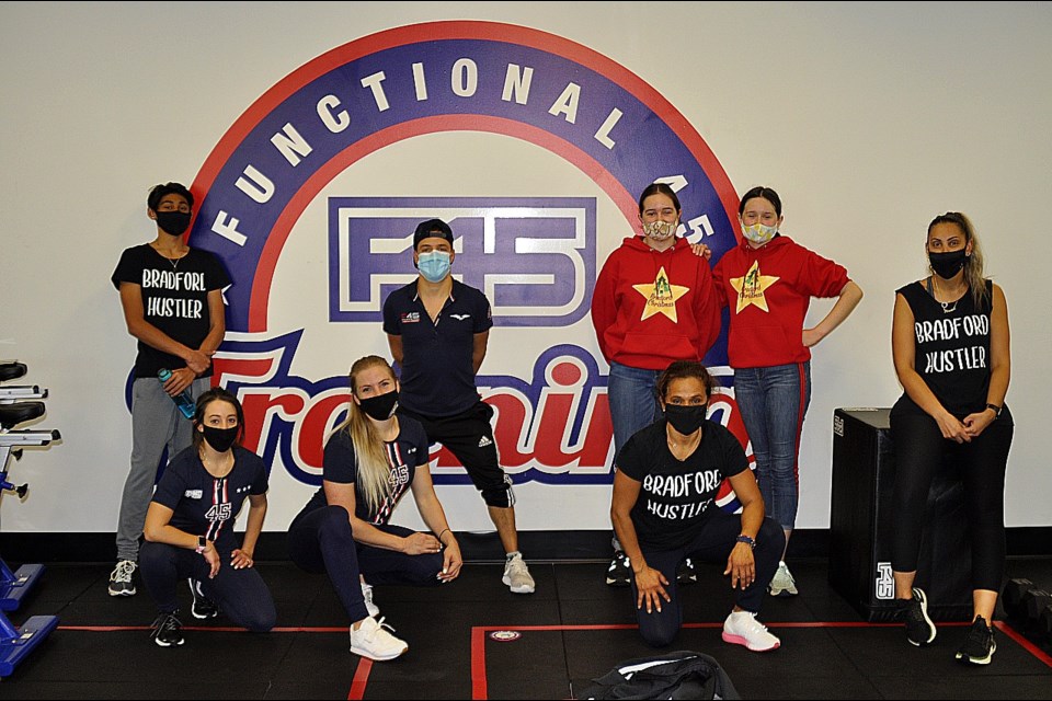 (Left-Right) Adam Qureshi, Laura Vitale (F45 Trainer), Megan Glynn (F45 Studio Manager), Christ Lombardi (F45 Owner), Sarah and Emily Dahlgren (A Bradford Christmas), Laura Bachon (Bradford Hustlers), Mariam Qureshi (Bradford Hustler). In support of A Bradford Christmas Workout Fundraiser.  JackieKozak/BradfordToday