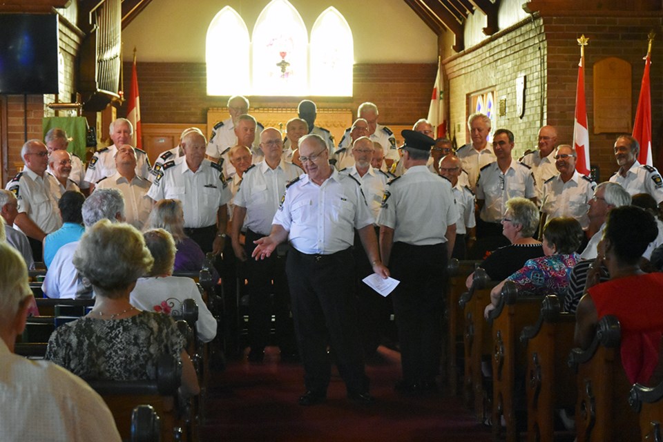 York Regional Police Male Chorus, with emcee Superintendent (Ret.) Lowell McClenny, perform at Trinity Anglican Church in Bradford, Sept. 16. Miriam King/BradfordToday