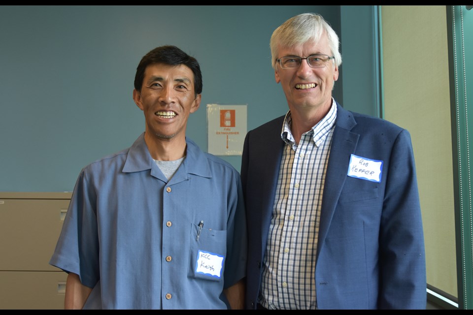 Kumi manager Keith Motoyama, left, chats with Bradford West Gwillimbury Mayor Rob Keffer at the Kumi Canada Corporation's 20th anniversary celebration. Miriam King/Bradford Today