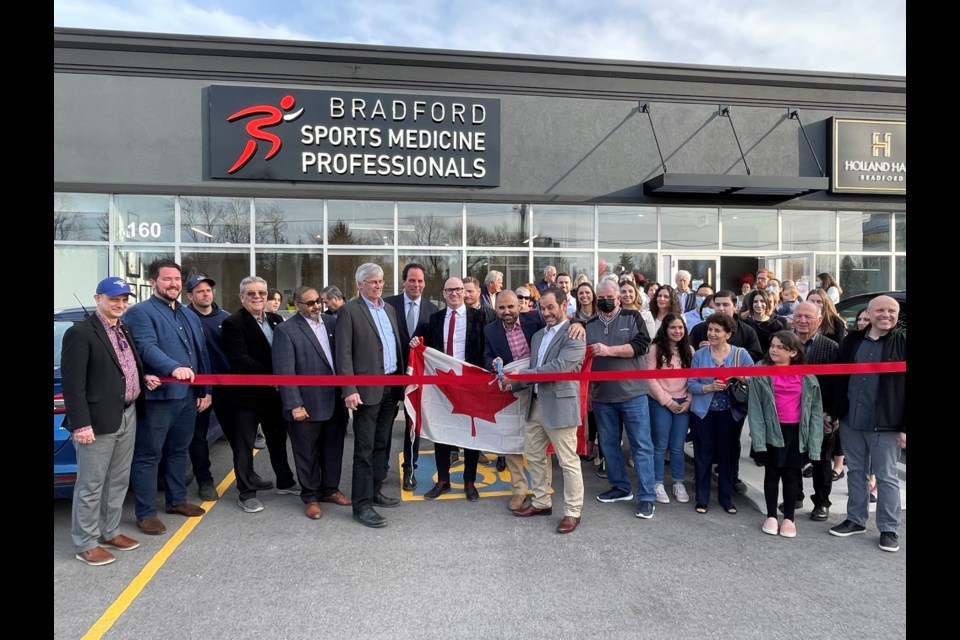 Friends and family filed in behind York-Simcoe MP Scot Davidson, Mayor Rob Keffer, members of council, and the Bradford Sports Medicine Professionals team of Giacomo Fabrizio, Mike Pameli, and Dr. Patrick Gamble for the grand opening of the clinic. 