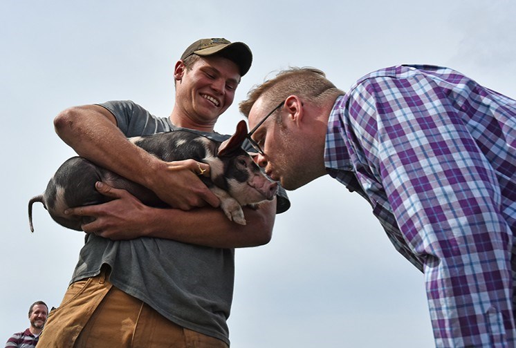 Teacher Joel Malley puckers up to kiss a piglet, at the BDHS Terry Fox Run, Sept. 27. Miriam King/BradfordToday