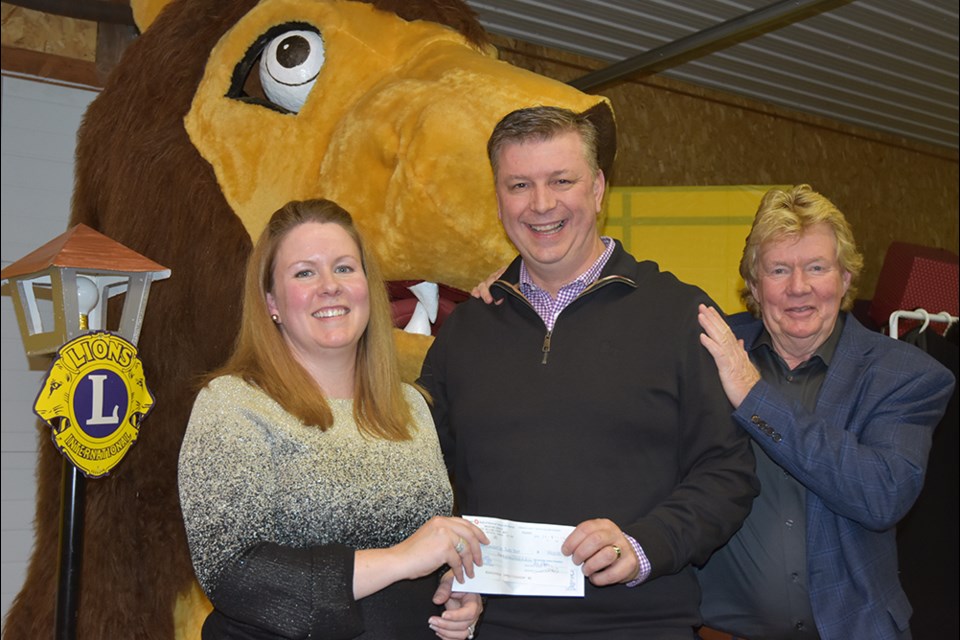 Mark Sheeler, centre, owner of the Bradford Canadian Tire Store, accepts a donation for Canadian Tire’s Jumpstart program from Robin Evans and daughter Becky Evans-Rutherford. Miriam King/BradfordToday