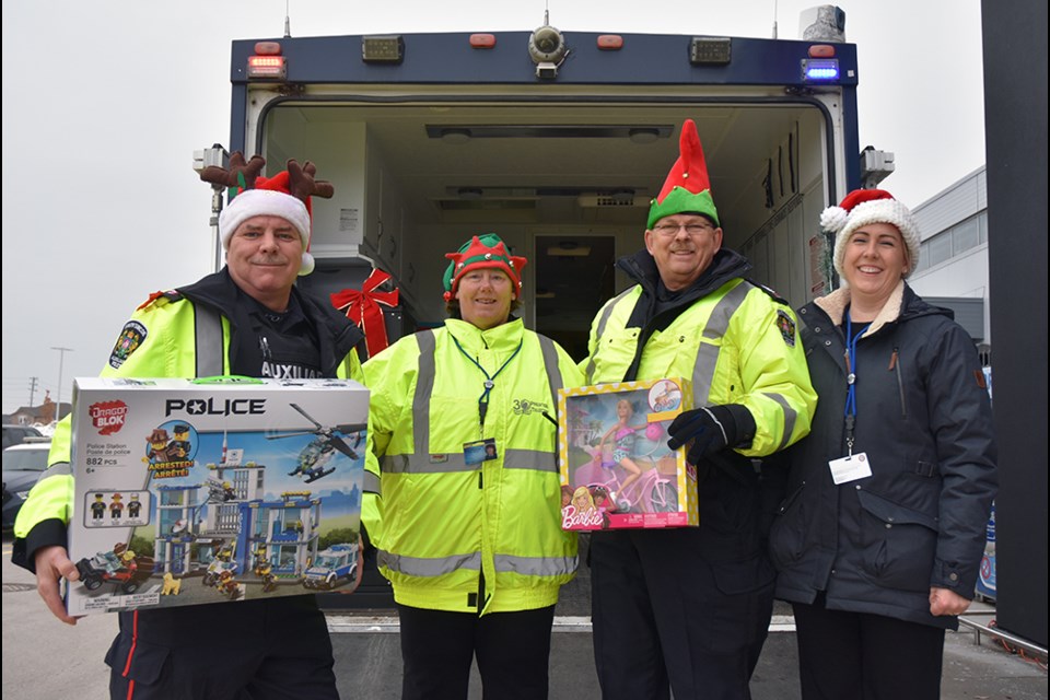 Auxiliary Officer Dave Cockburn, volunteer Cheryl Warnes, Auxiliary Chris Moran and Shelley Pope accepted donations of new unwrapped toys to help build Toy Mountain, at the Alcona Canadian Tire on Nov. 30. Miriam King/BradfordToday