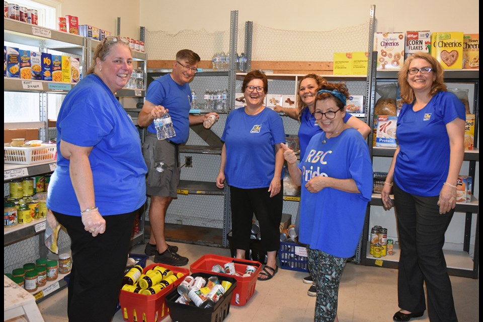 Team RBC helps out once again at the Helping Hand Food Bank, this time washing shelves before restocking. Miriam King/Bradford Today