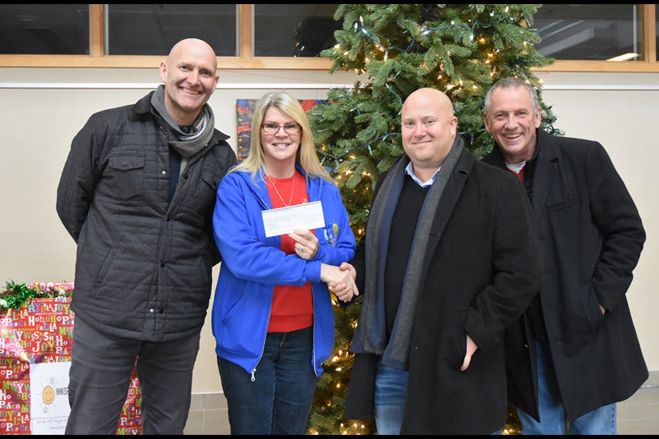 From left, Wayne Clements of 100 Men who Give a Damn in Innisfil, Debra Harrison of Innisfil Christmas 4 Kids, and 100 Men members Brian Sametz and Michael Tough, at cheque presentation. Miriam King/Bradford Today