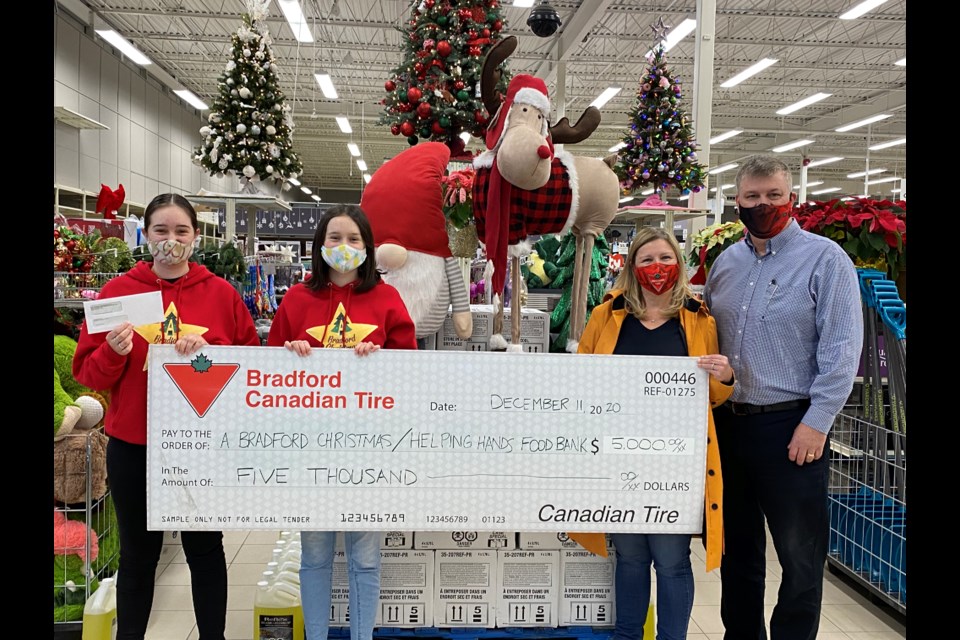 Canadian Tire Bradford store owners Mark and Diana Sheeler donated $5,000 to A Bradford Christmas charity, run by sisters Emily and Sarah Dahlgren. Natasha Philpott/BradfordToday