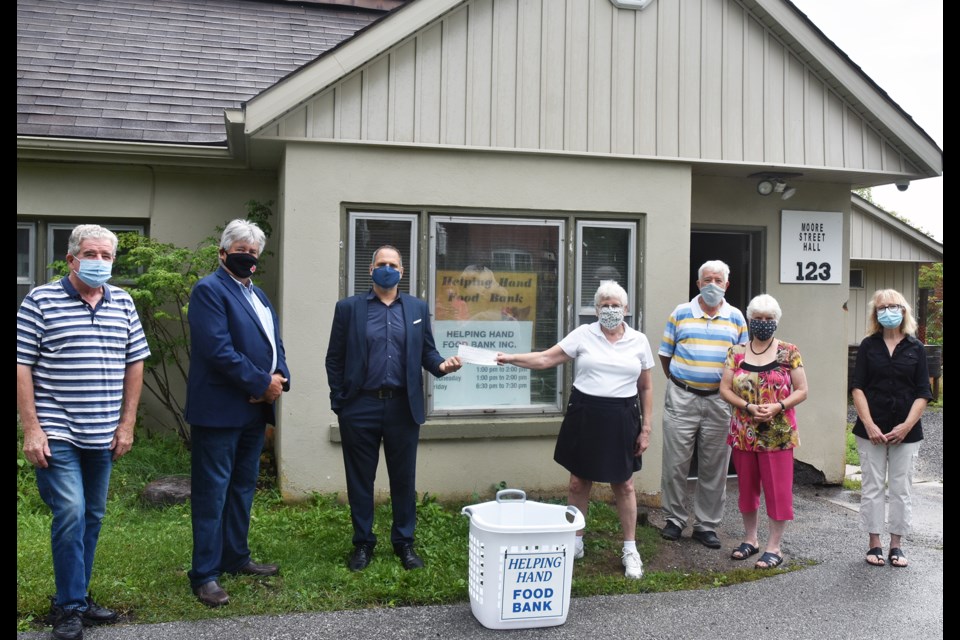 From left, Bradford food bank board member John Blake watches as Ron Orr and John Spinelli of Peel Mutual Insurance Co. present a cheque for $4,500 to the Helping Hand Food Bank’s president Anne Silvey, secretary Carol Belanger, Treasurer Alvin Belanger, and member Cyndie Pasquarella. Miriam King for BradfordToday