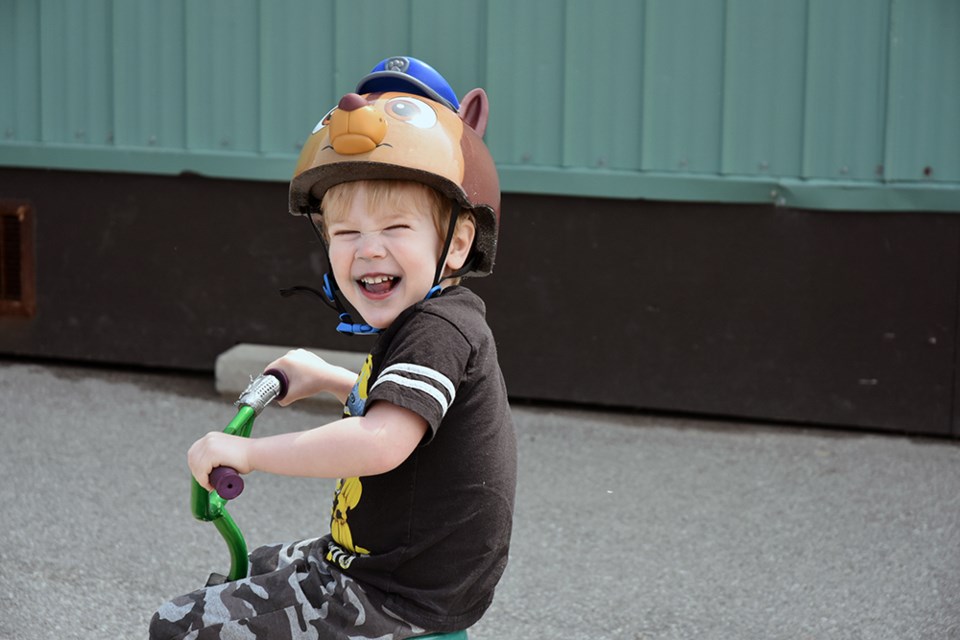 Youngster wears his helmet as he rides his tricycle, at the Bike Rodeo. Miriam King/Bradford Today