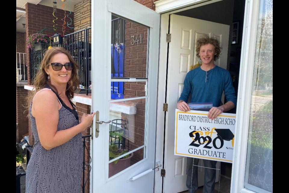 Graduate Jake Johnson was happy to receive his lawn sign and cap from BDHS teacher Tracy Brownlee. Natasha Philpott/BradfordToday