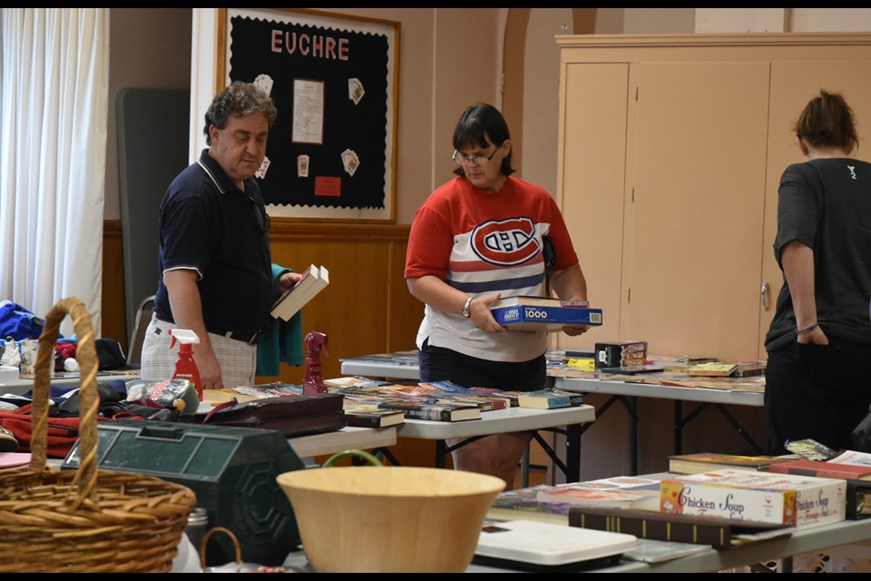 Bargain hunters check out the books, games and other items available for a donation. Miriam King/Bradford Today