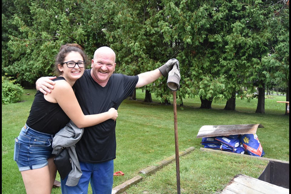 Tom Hamilton and daughter Skyler get grilling in Bond Head, Aug. 17, despite the rain. Miriam King/BradfordToday