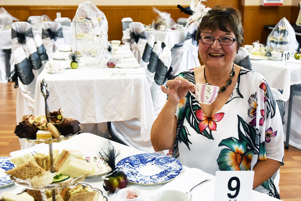 Cheryll Strong, in charge of the Victorian Tea, makes sure every place setting is perfect. Miriam King/BradfordToday