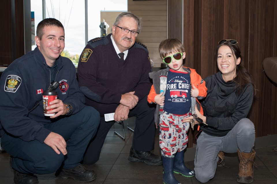 There’s a new fire chief in town. Colton Saunders came dressed for the job. With his mother Jessica, Chief Kevin Gallant and firefighter Brian Donnelley. Paul Novosad photo 