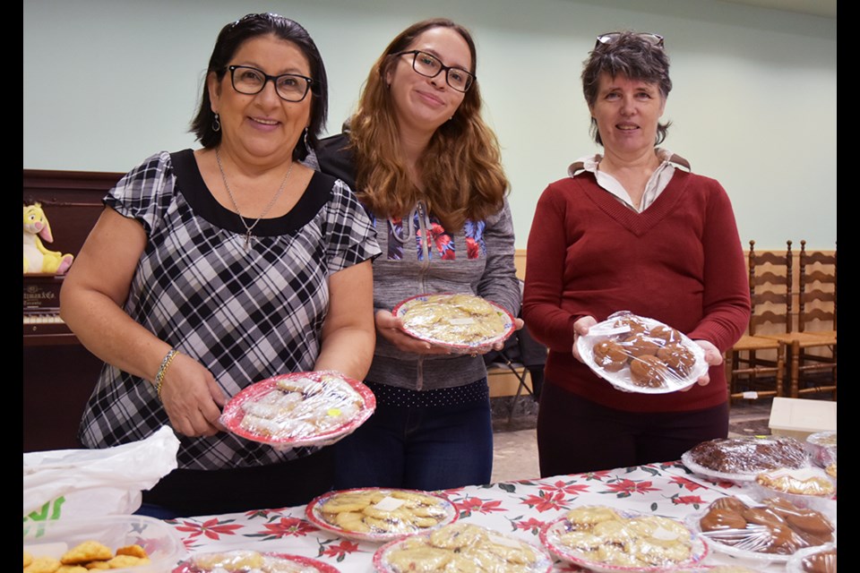 From left, Esperanza Valarezo, Toni Recino and Brigette Tophen with an array of home-baked goodies at the Splendour of Christmas Bazaar. Miriam King/BradfordToday