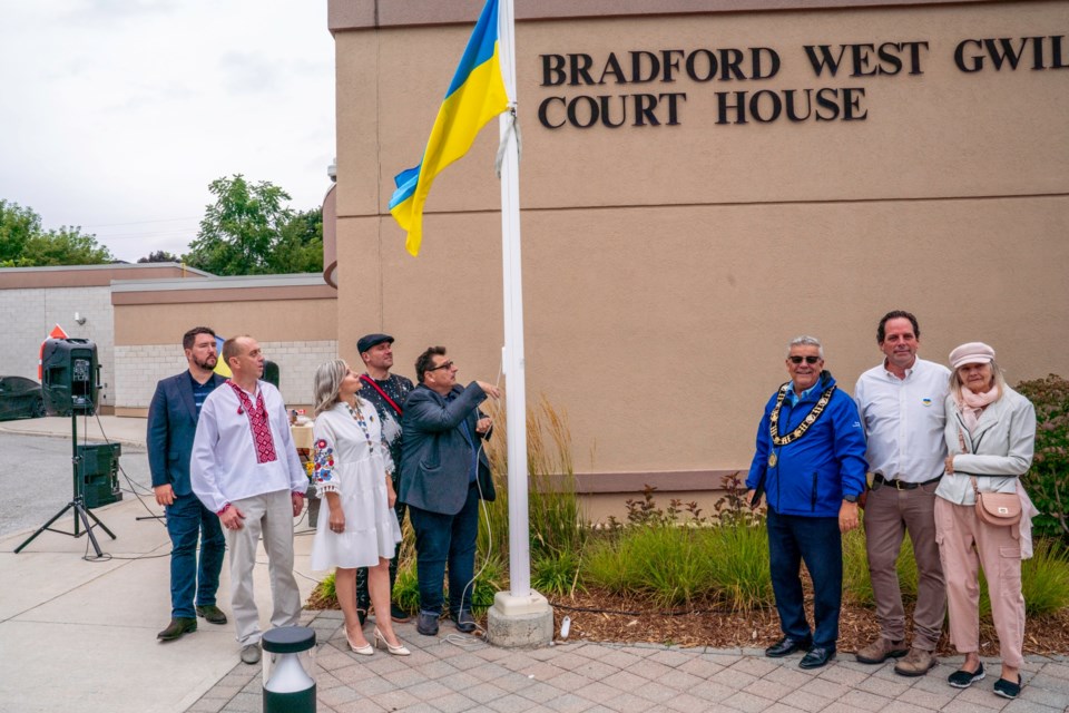 Coun. Peter Dykie, who is of Ukrainian descent, raises the flag at the Ukraine Independence Day flag -raising on Wednesday. 