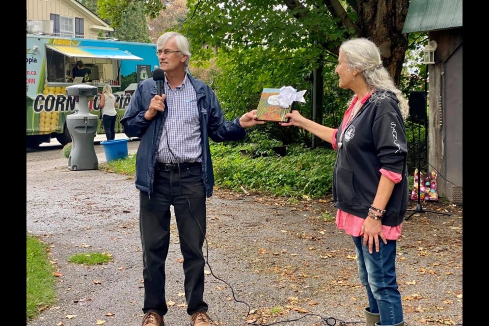 Mayor Rob Keffer presents owner Brenda Bronfman with a certificate of congratulations on the sanctuary's 10 year anniversary 