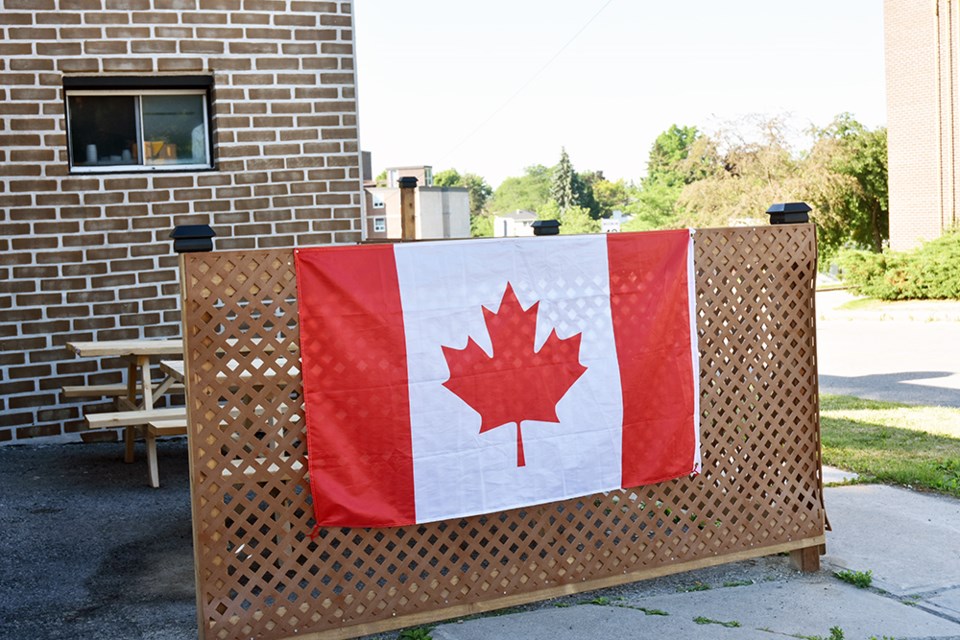 A Canadian flag hangs on the fence of a patio in downtown Bradford. Miriam King/Bradford Today