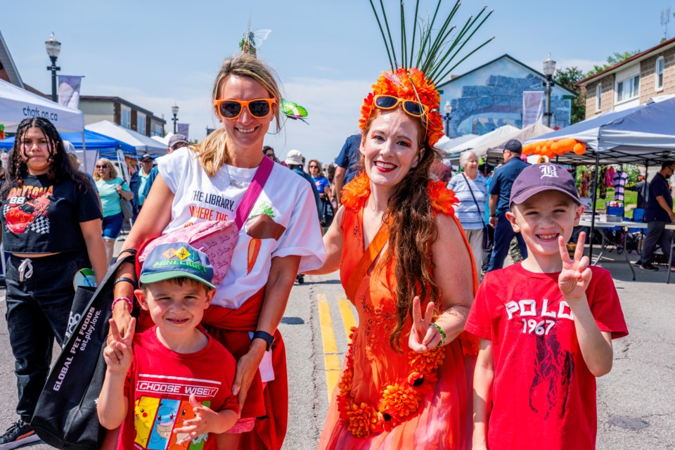 Natasha, Chad and Chase Philpott pose with the Carrot Queen. 