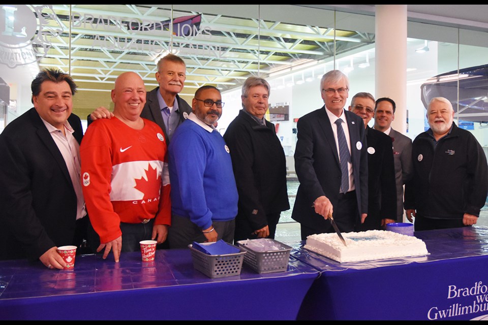 Welcoming residents to the New Year's Levee, from left, Coun. Peter Dykie Jr., Mark Contois, Gary Baynes, Raj Sandhu, Ron Orr, Mayor Rob Keffer preparing to cut the cake, Deputy Mayor James Leduc, Coun. Peter Ferragine and Gary Lamb. Miriam King/Bradford Today