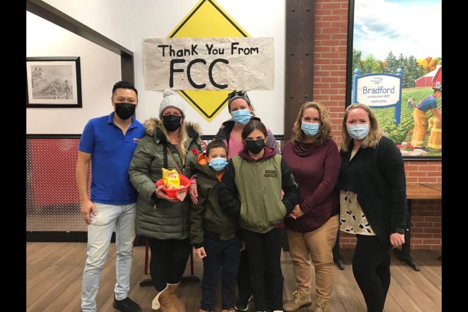 Owner John Chang (left) of Firehouse Subs with parents and children from Fred C. Cook during the first week of fundraising initiatives to support the school. (Also pictured: Rosi Martin (second from right). 