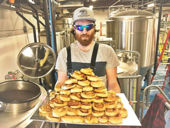 Market Brewing Co.'s brewer Josh Uttley with the donated cinnamon buns from Sweet B's Bakery in Bradford. Submitted photo/Market Brewing Co.