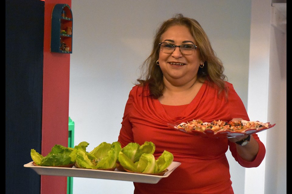 Rose Coba serves up platters of fresh guacamole and other appetizers at the grand opening of Guacamole Mexican Bistro. Miriam King/Bradford Today