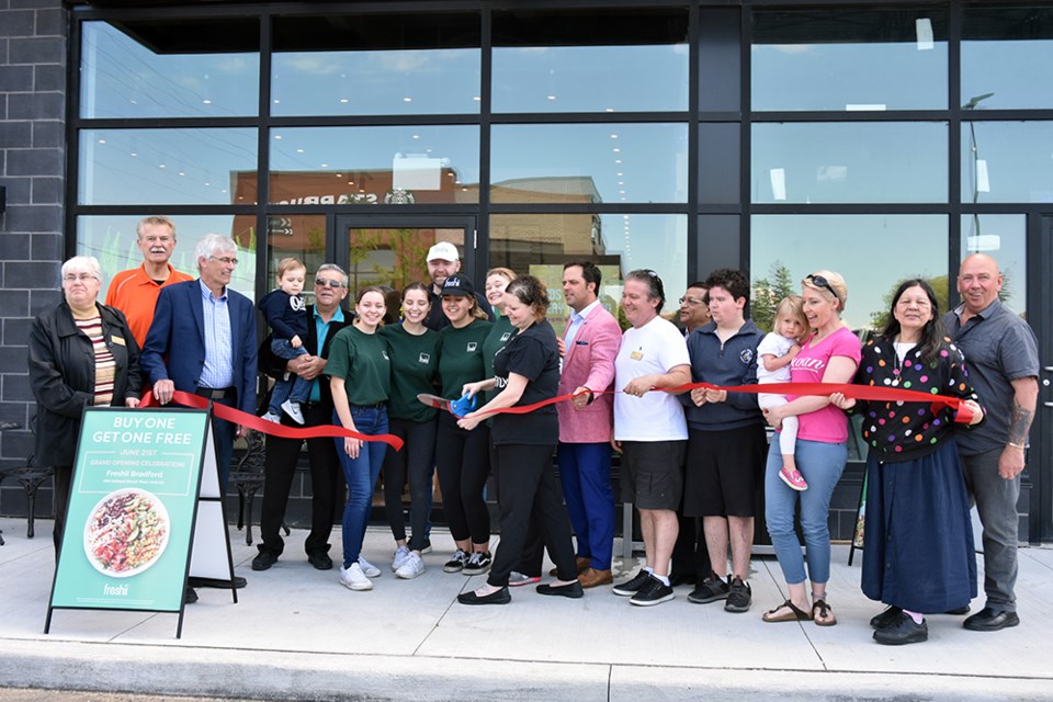 Cutting the ribbon to officially open Bradford's Freshii restaurant. Miriam King/Bradford Today