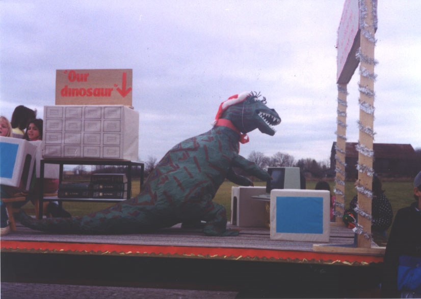 "Bruno Bronty" the dinosaur on a BWG Public Library float in the Santa Claus Parade in 1989. BWG Public Library Archives 