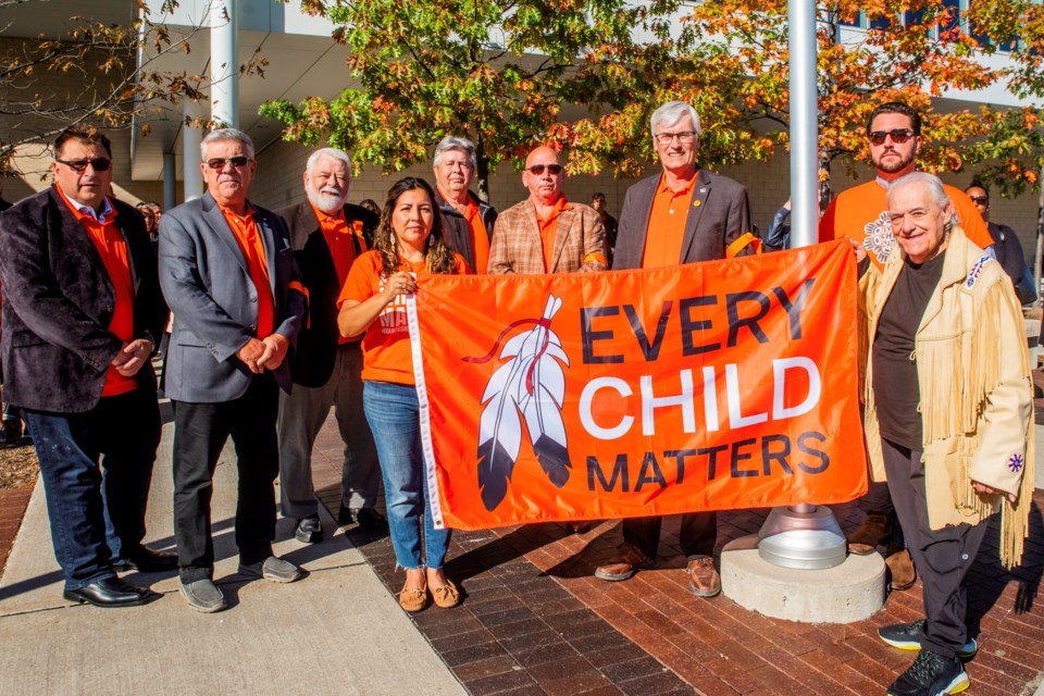 Community members come out on Friday morning for the smudging ceremony and Every Child Matters flag raising